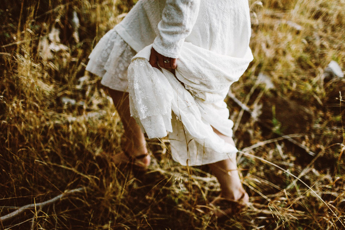 bride hiking up dress to walk