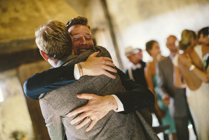 groom hugging guest