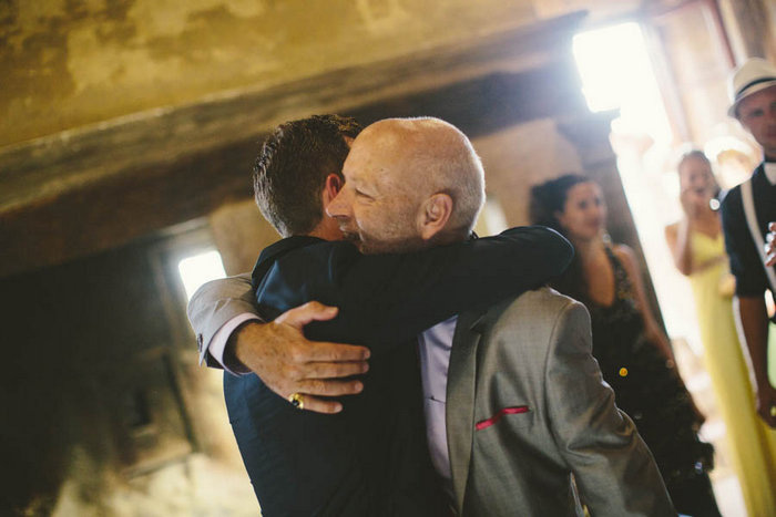 groom hugging guest