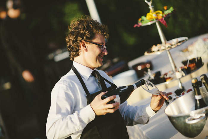 server pouring champagne