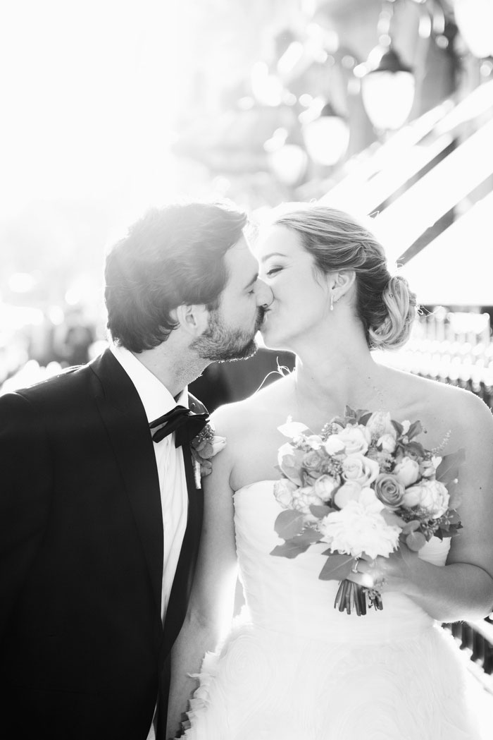 bride and groom kissing in Paris streets