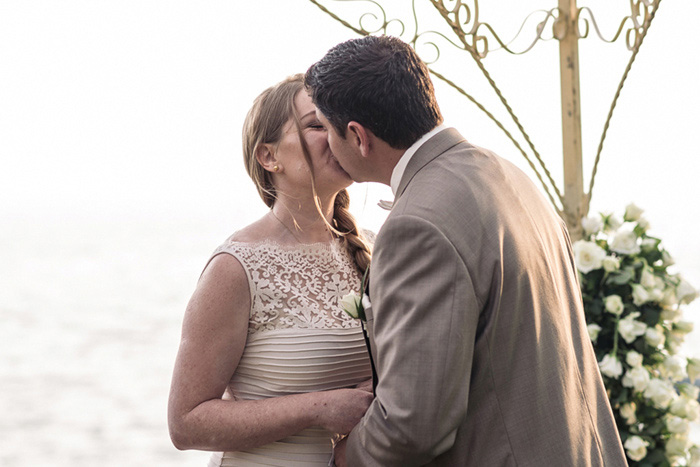 bride and groom first kiss