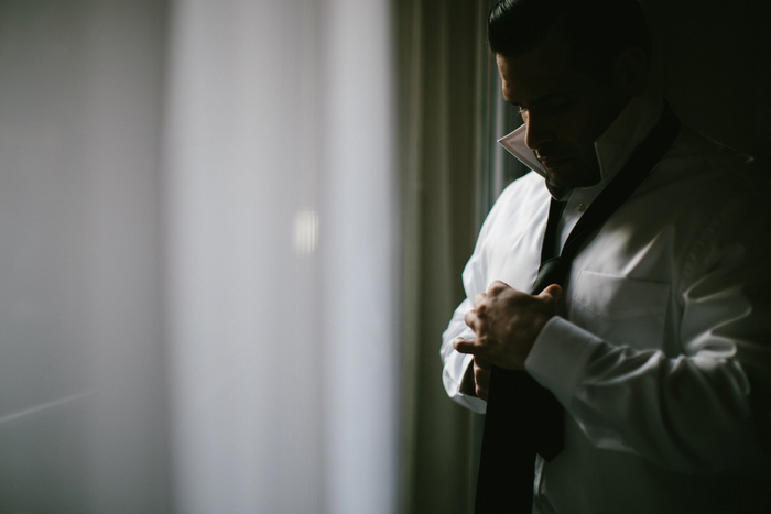 groom tying his tie