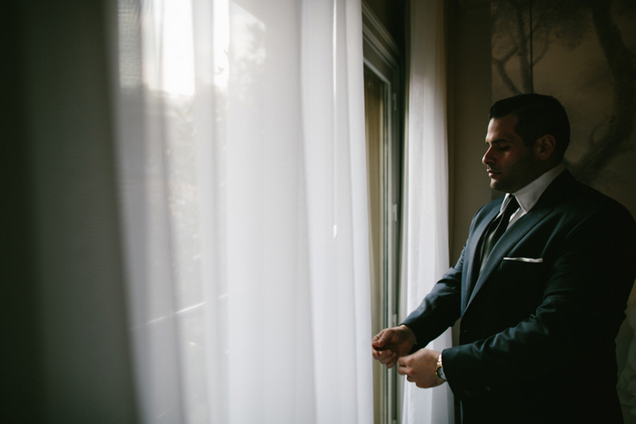 groom adjusting his jacket sleeves