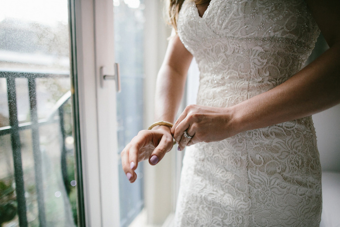 bride putting on bracelet