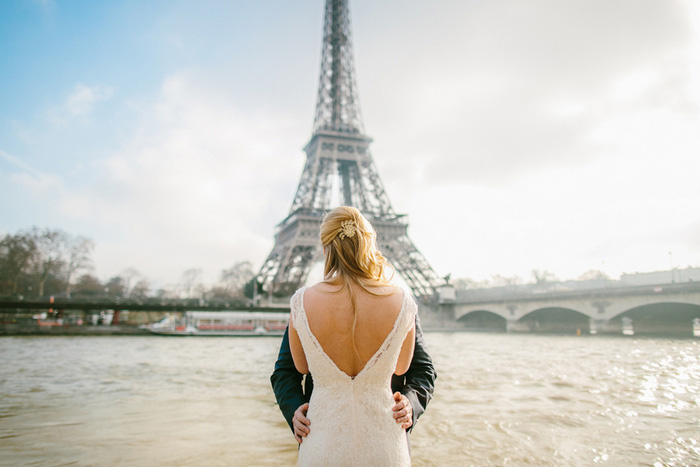 bride and groom kissing in front of Eiffel Tower