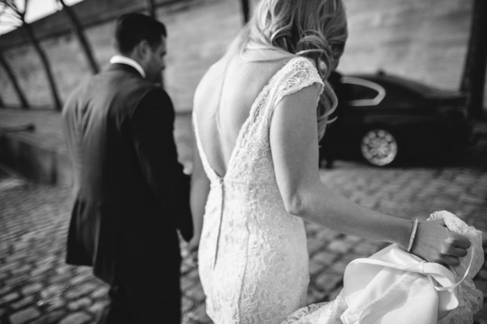 bride and groom walking to the louvre