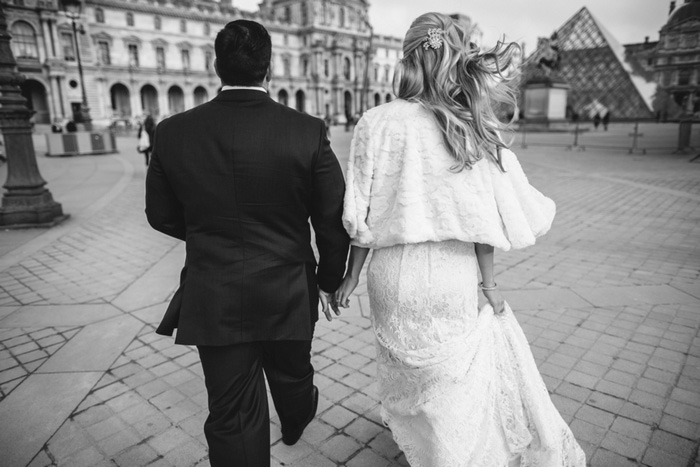 bride and groom walking to the louvre