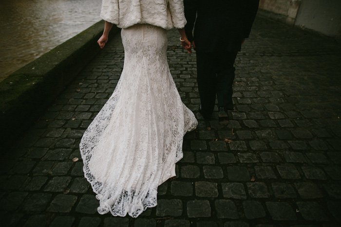 detail of bride's gown train as they walk