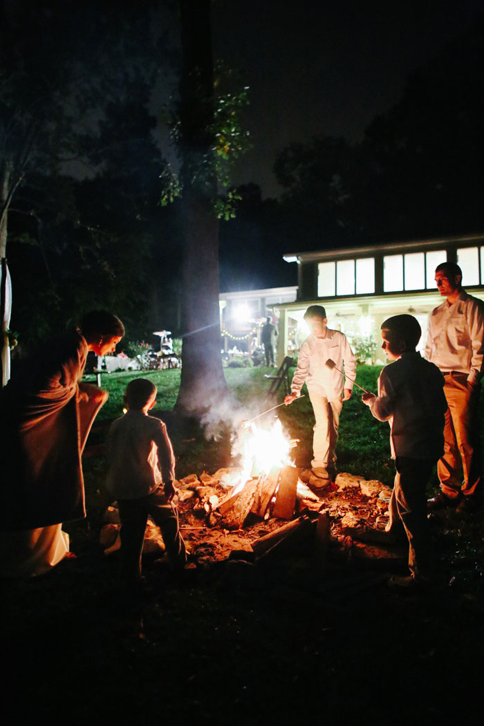 wedding guests around bonfire