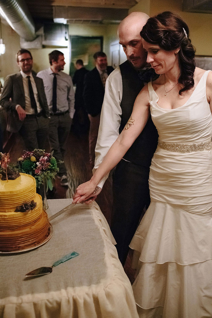 bride and groom cutting the cake