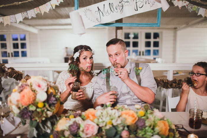 bride and groom drinking through Mrs. and Mr. straws