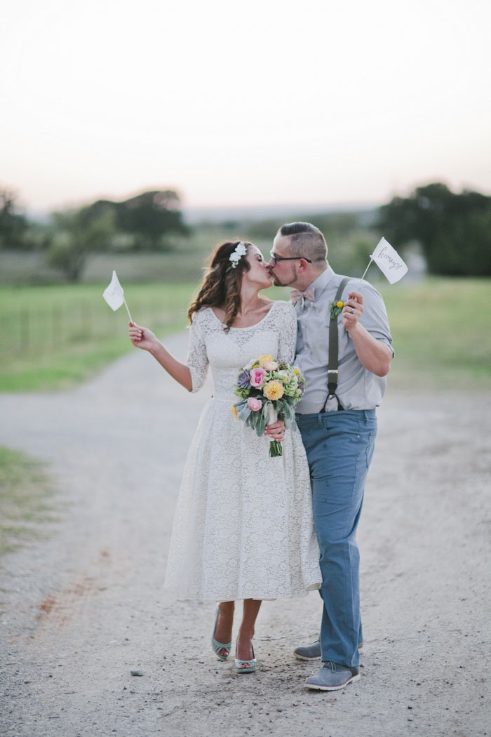 bride and groom with yay flags