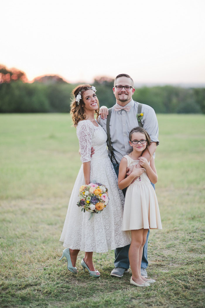 bride and groom with daughter