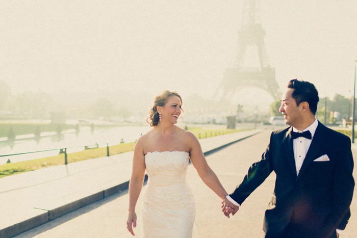 bride and groom walking hand in hand in Paris