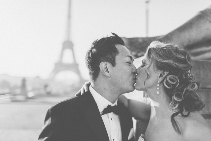 bride and groom kissing in front of Eiffel Tower