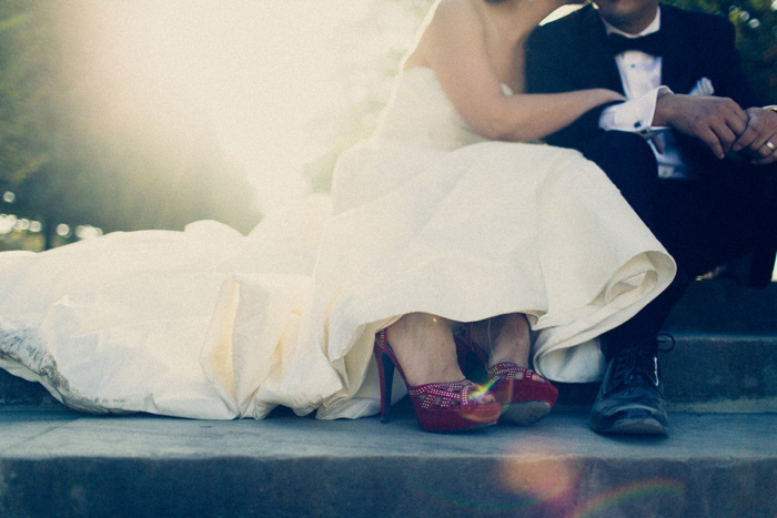 bride and groom sitting on Paris park steps