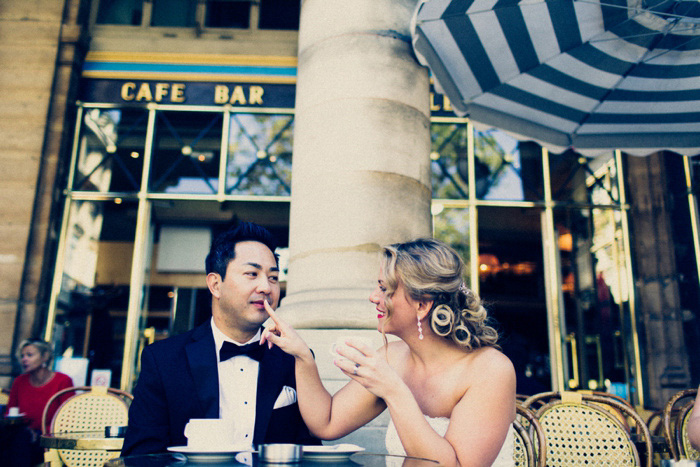 bride and groom having coffee in Paris