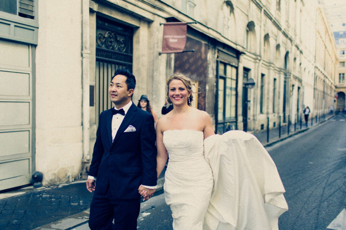 bride and groom walking down Paris street