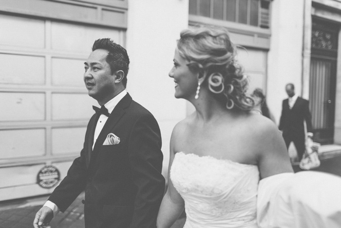 bride and groom walking down Paris street