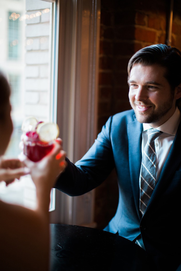 bride and groom clinking glasses