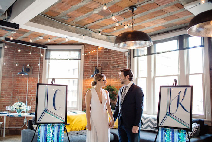 bride and groom next to monogram letters