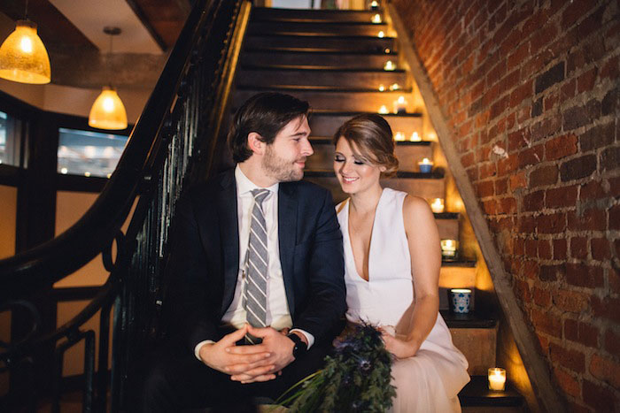 bride and groom on candlelit stairs