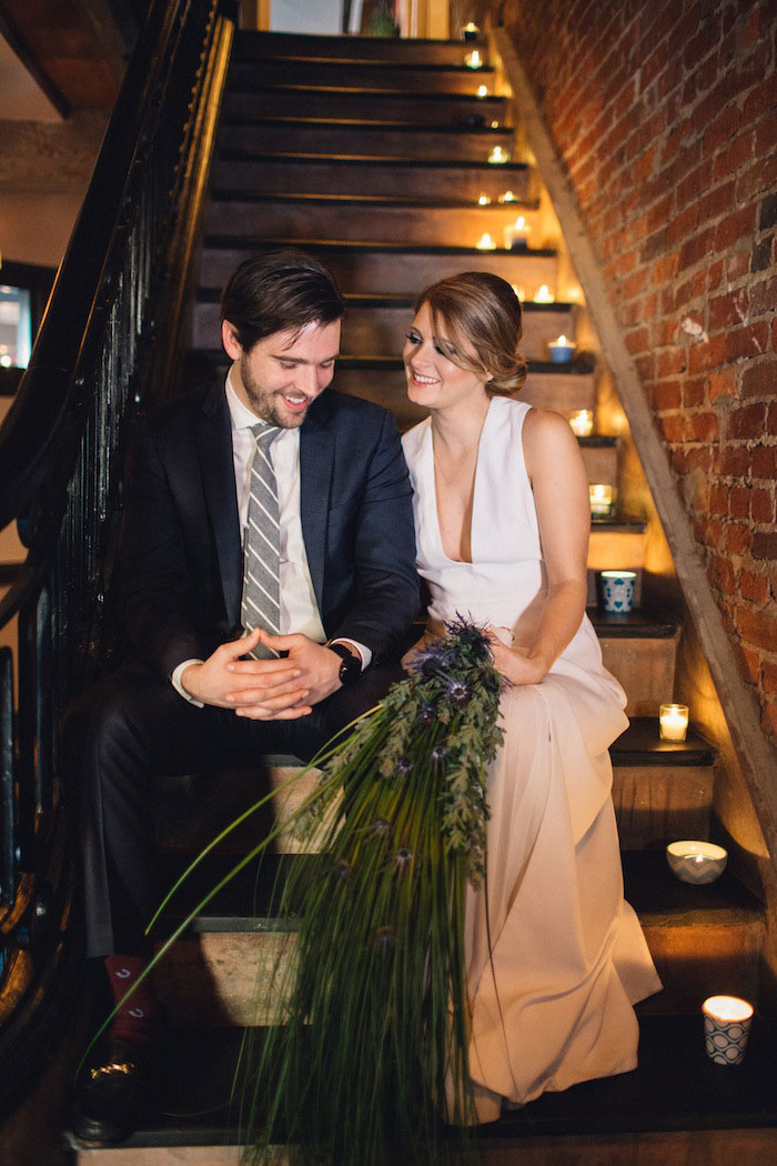 bride and groom on candlelit stairs