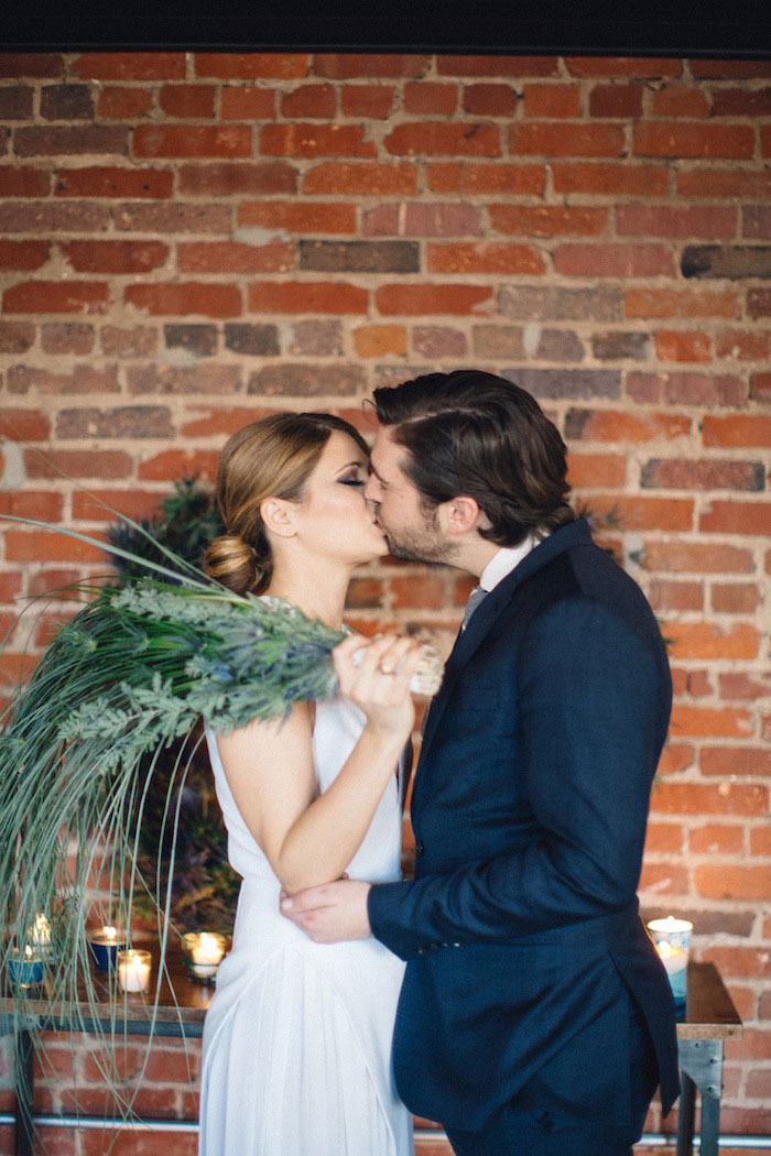 bride and groom first kiss