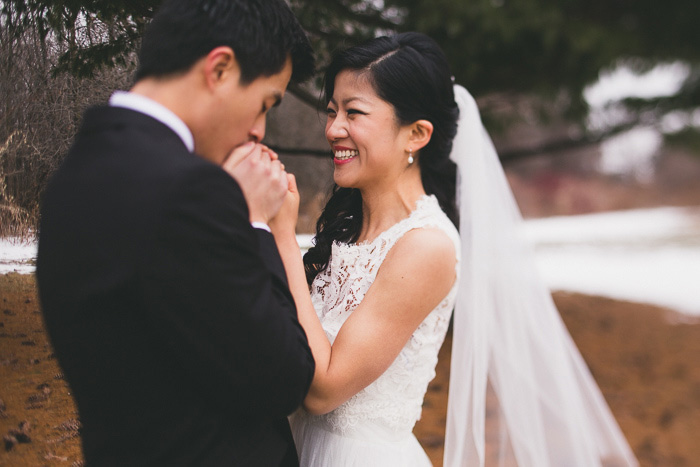 groom kissing bride's hands