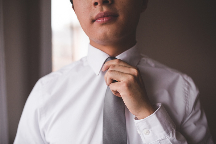 groom adjusting tie