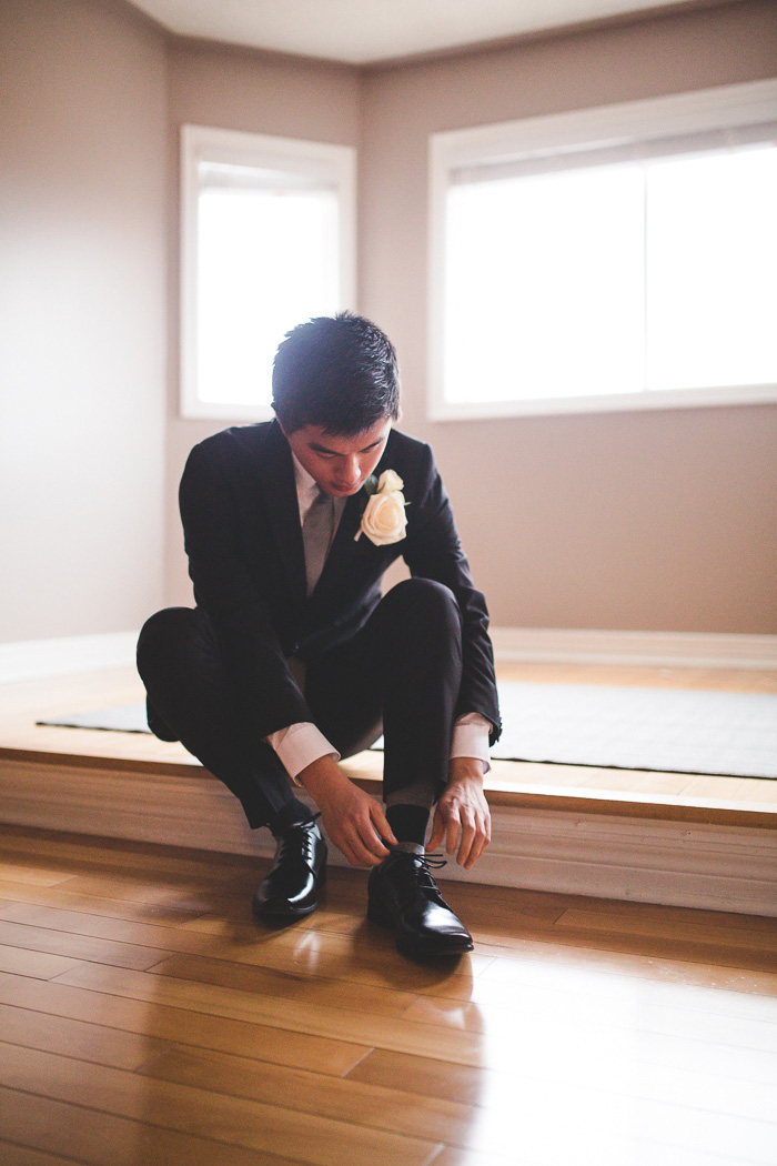 groom tying his shoes