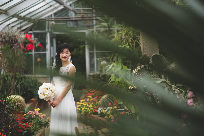 bride portrait through plant leaves