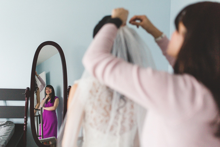 bride having her veil put on