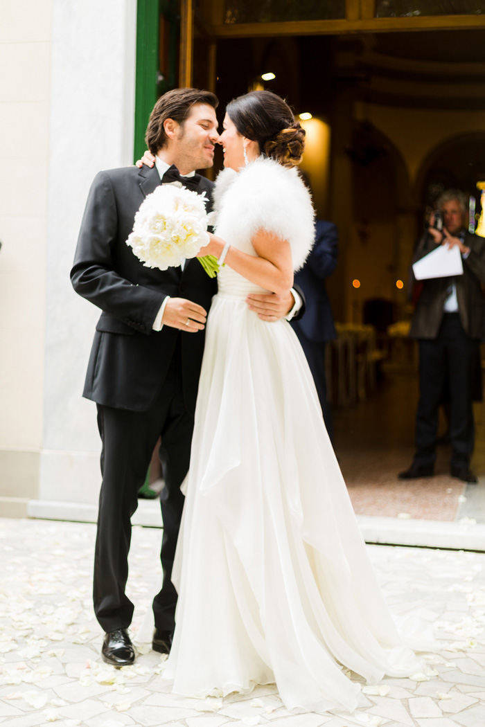 bride and groom kissing outside church