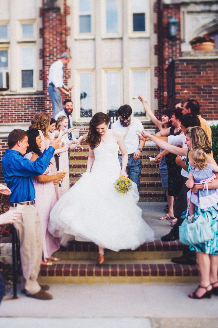 bride and groom exit with rice toss