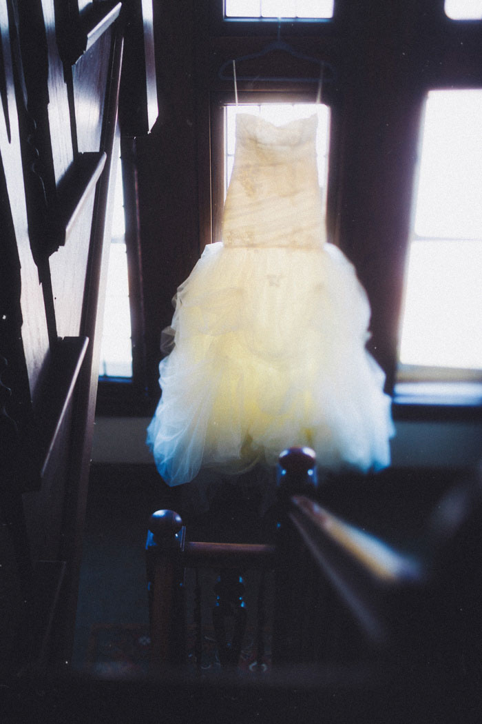 wedding dress hanging in stairwell