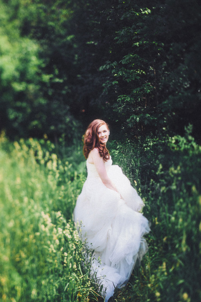 bride walking through tall grass