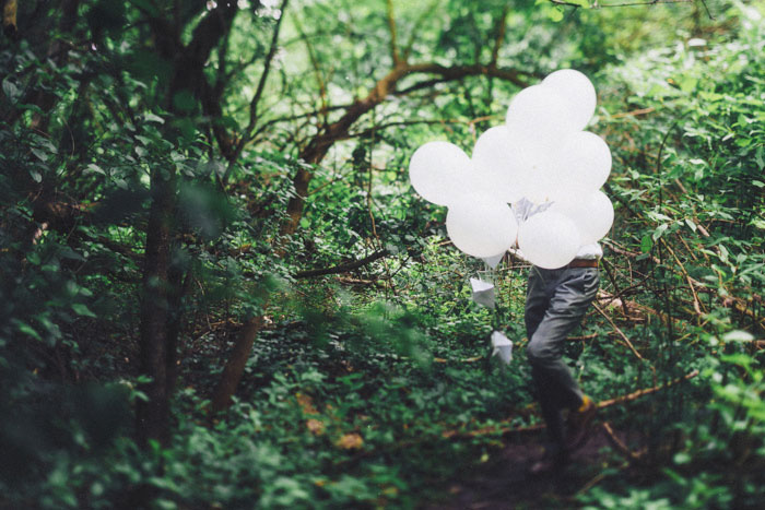 groom with white balloons
