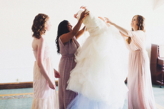 bride pulling dress over her head