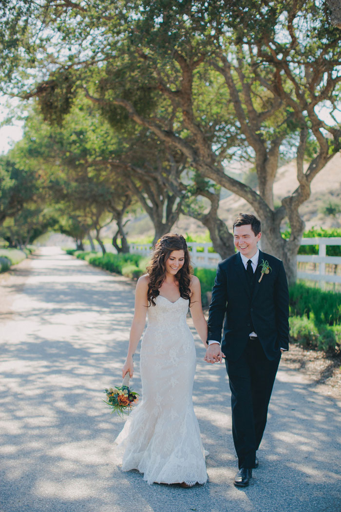 bride and groom walking down road