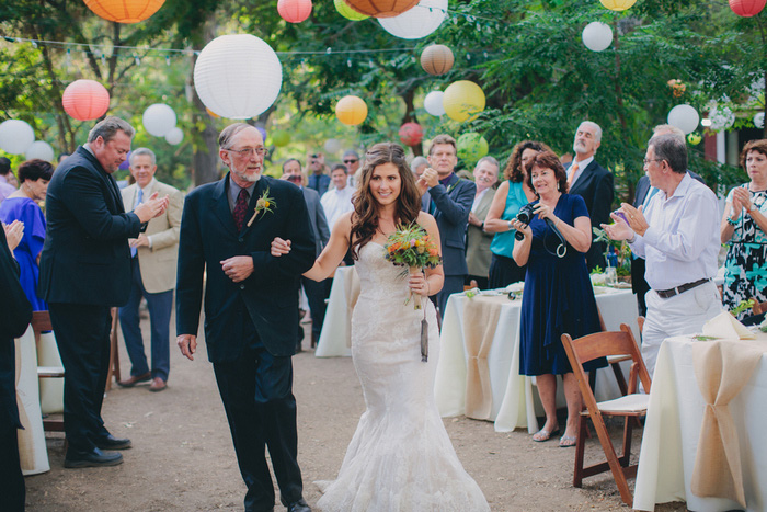 bride walking down aisle with father