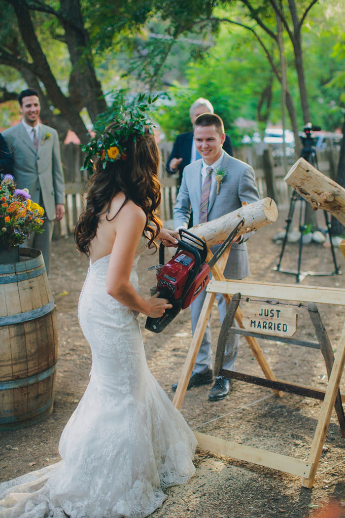 bride cutting log with chainsaw