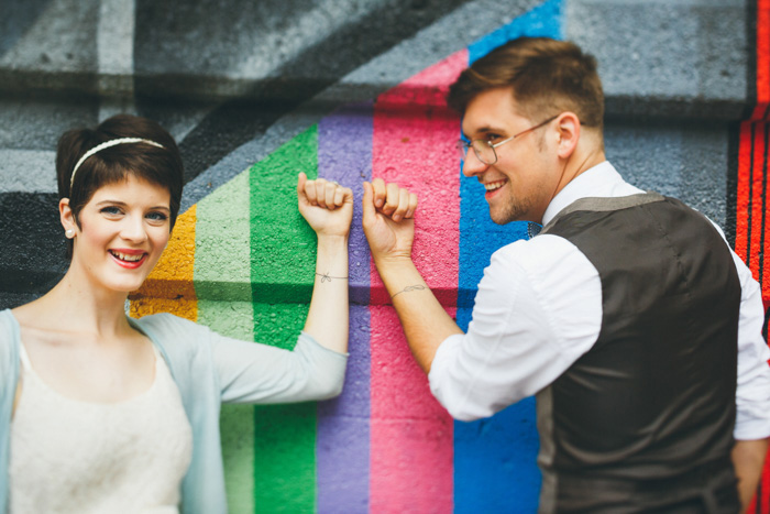 bride and groom showing off matching tattoos