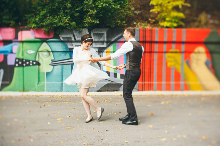 bride and groom dancing in the street