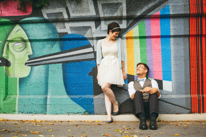 bride and groom portrait in front of colorful mural