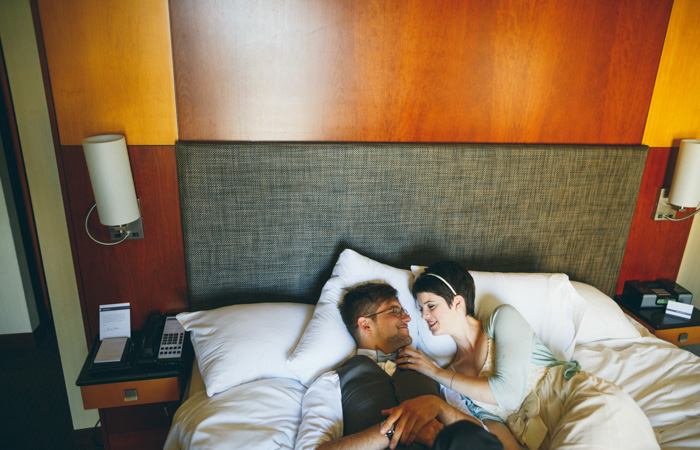bride and groom lying in bed