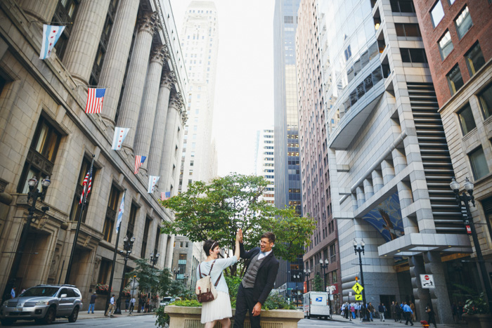 bride and groom high fiving on traffic island