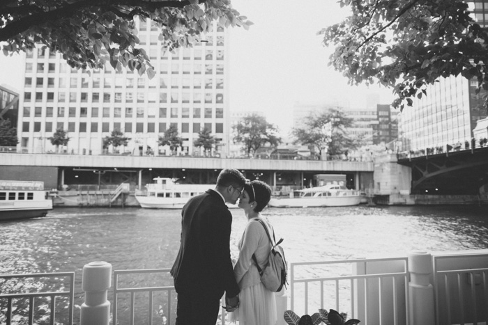 bride and groom kissing by the water