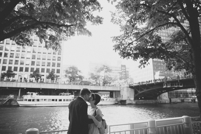 bride and groom kissing by the water